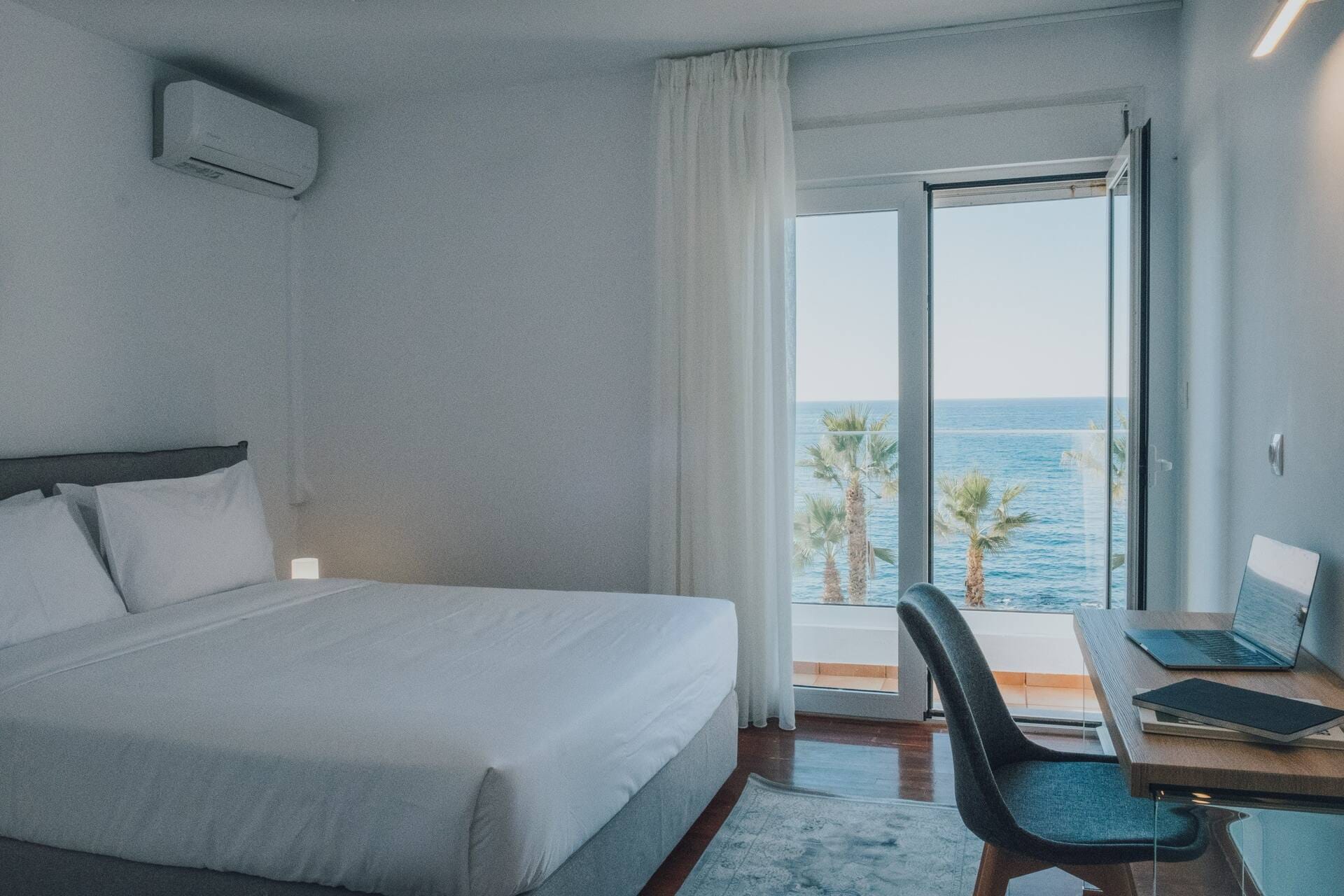 Bedroom with balcony doors opening to the sea