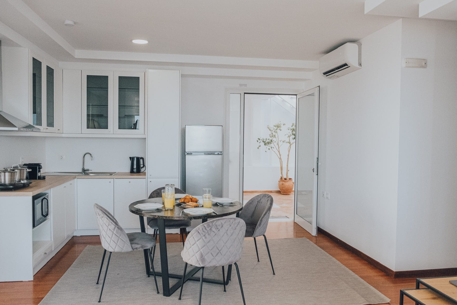 Kitchen with refrigerator and a dining table beside the patio door
