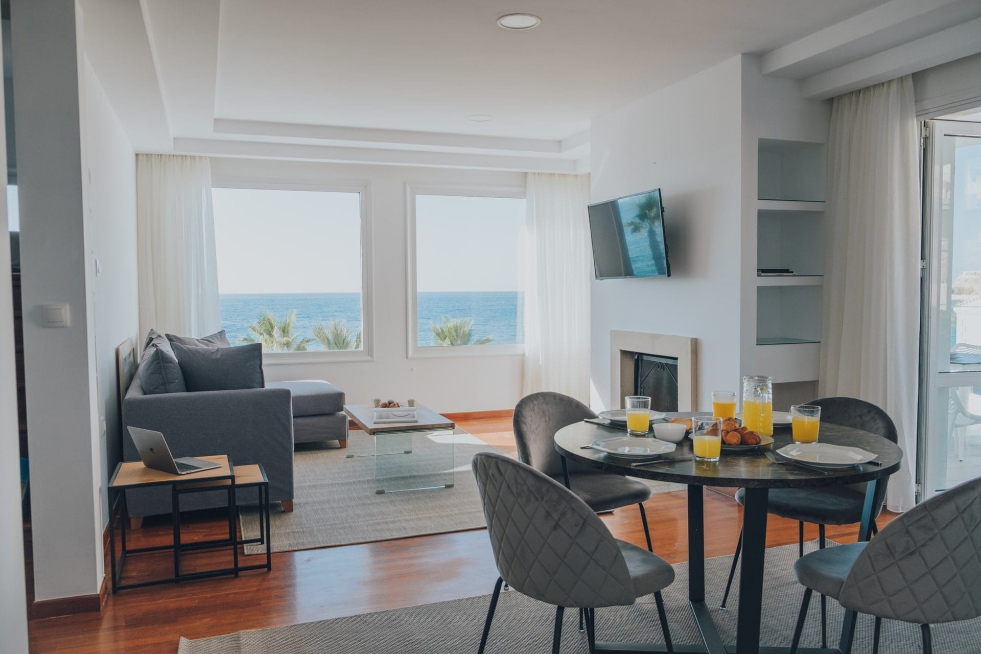 Living and dining area with a fireplace and sea-facing windows