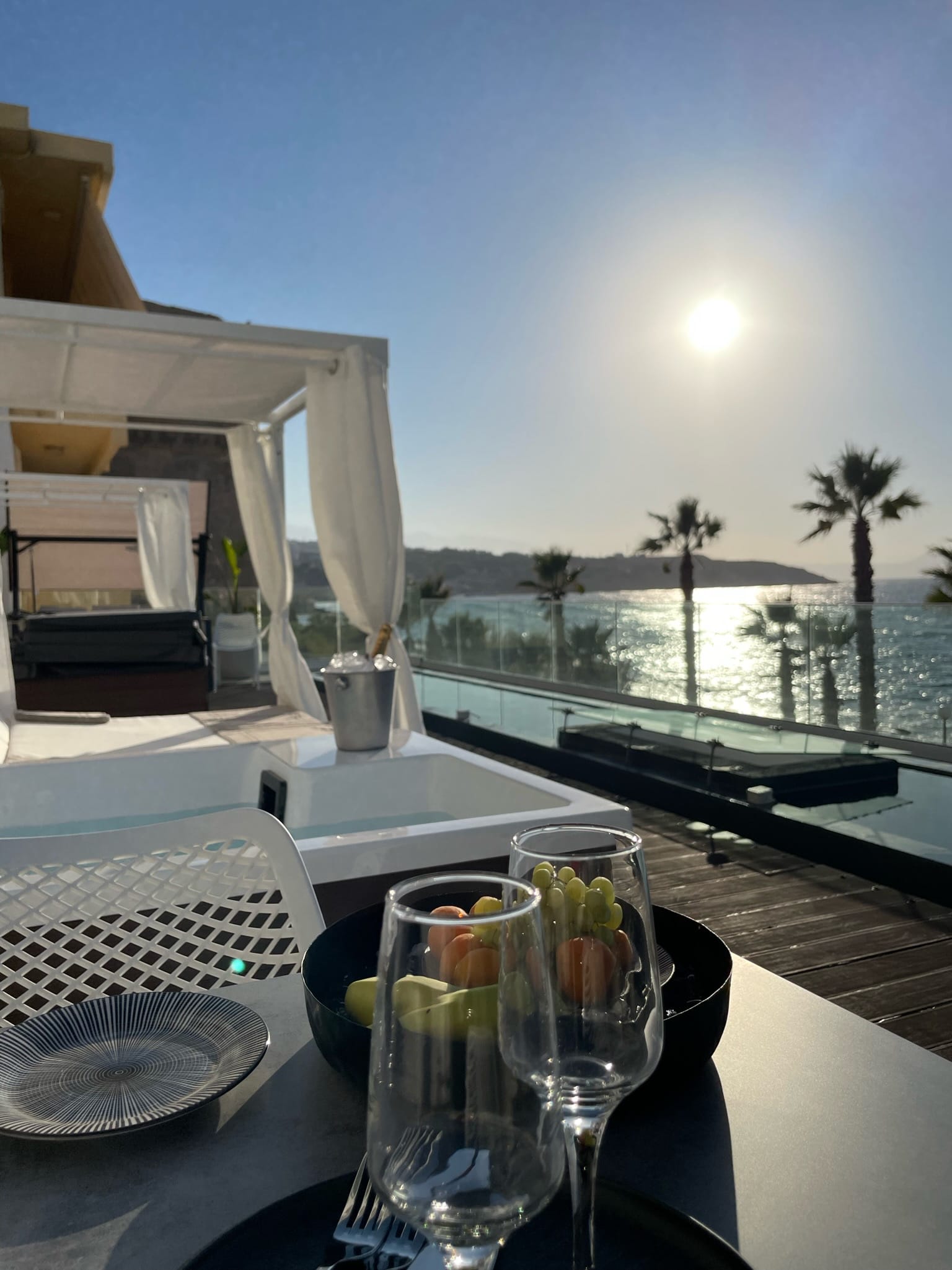 The front deck at sunset with the canopied jacuzzi facing the sea