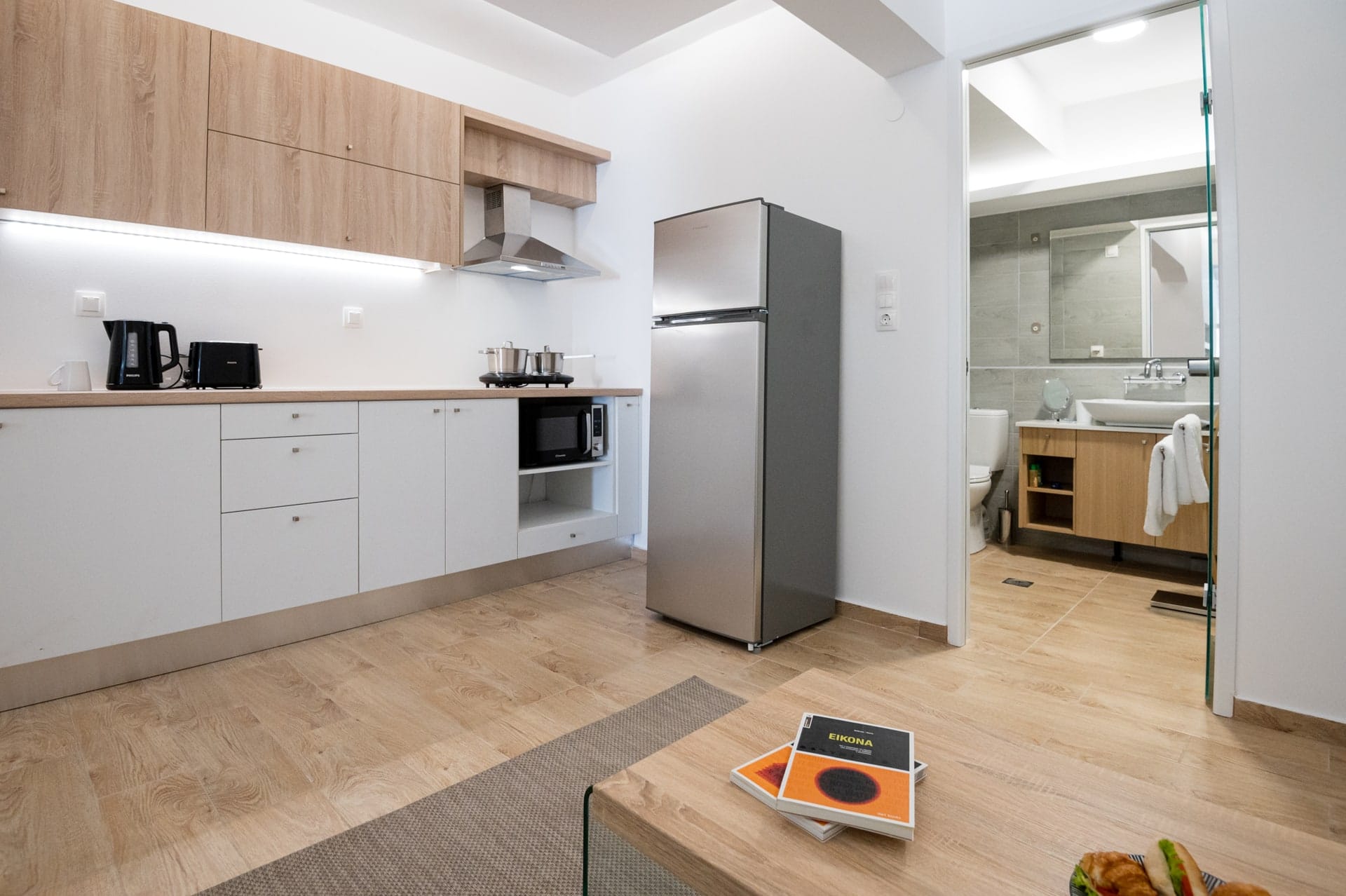 Kitchen with refrigerator and worktop beneath the staircase