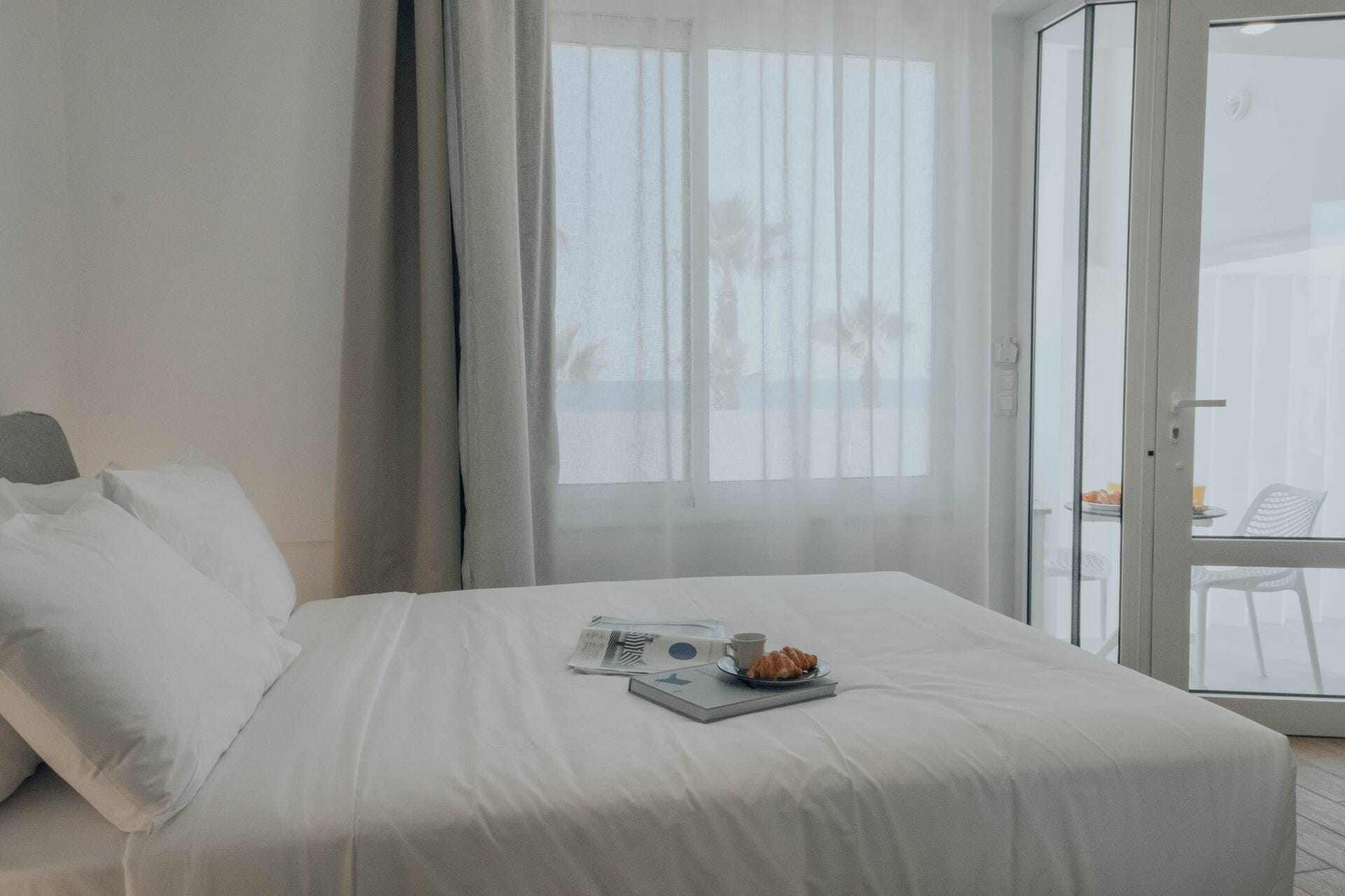 Bed facing the balcony doors and the sea