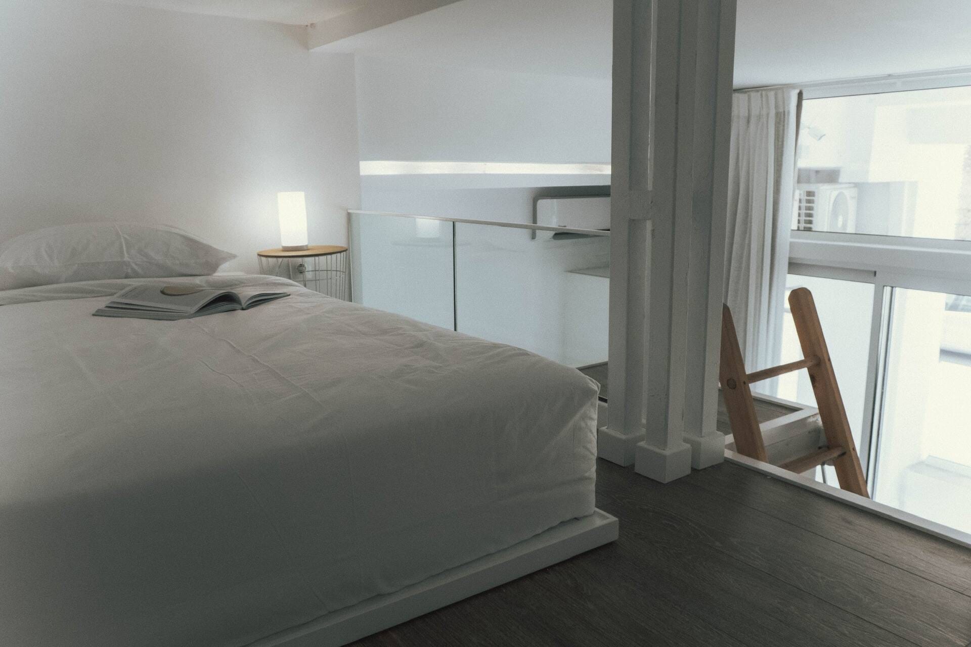 Studio interior with the upper level above the bed